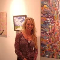 <p>Wendy Petta-Goldman of Westport with her painting &quot;Curious Tides,&quot; part of the &quot;Deja New&quot; exhibit in Norwalk.</p>