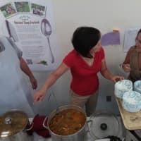 <p>Volunteers serve soup, pesto and bread. </p>