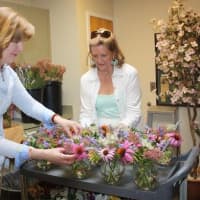 <p>Mary Tanzi and Carroll Yanicelli, flower volunteers, prepare cut flowers for display in 
Waveny Care Centers Main Dining room.</p>