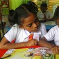 <p>Students read together in the school library in Sri Lanka.</p>