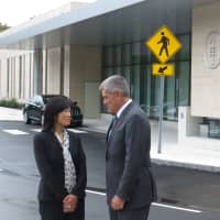 <p>Dr. Chan Dang of Harrison and Dr. Richard R. Barakat, deputy physician-in-chief, talk outside the new medical center at 500 Westchester Ave.</p>