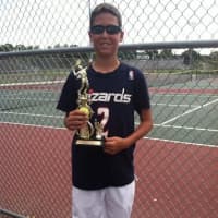 <p>A trophy winner in a USTA Tournament condcuted by Slammer Tennis World of Norwalk shows his wares.</p>