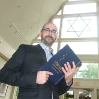 <p>Rabbi Jay TelRav at Stamford&#x27;s Temple Sinai, stands in the atrium, as he prepares for Yom Kippur on Friday.</p>