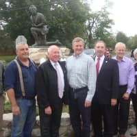 <p>Westport officials and those associated with the restoration of the Minute Man Monument celebrate the work being done on the landmark.</p>