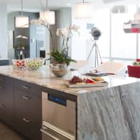 <p>The kitchen included a center island with granite countertop.</p>