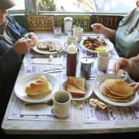 <p>Guests enjoy bagels, pancakes, eggs and other breakfast foods. </p>