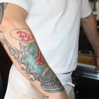 <p>Sprague&#x27;s dedication and love for the restaurant is evident in the tattoo on his arm. </p>