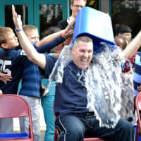 <p>Principal Matt Curran takes the ALS challenge, and gets drenched by students. </p>