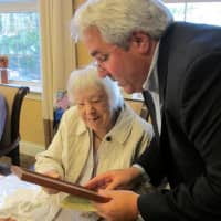 <p>Mayor Steve Ecklond reading the proclamation to Tuckahoe centenarian Mary Finoia.</p>