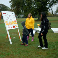 <p>Student volunteers assist a visitor at KIDZFEST in Norwalk last Saturday.</p>