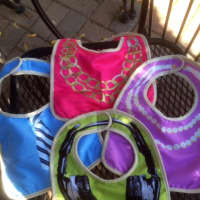 <p>Sunshine &amp; Clover in Croton-on-Hudson offers bibs with headphones and necklaces on them.</p>