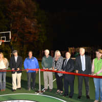 <p>A ribbon cutting is held for the opening of the new basketball court at Bedford Village Memorial Park.</p>