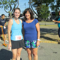 <p>Ginger Katz, right, poses with first-place female Elizabeth Thomas, who finished the 16th annual Ian James Eaccarino Memorial Nine-Mile Race with a time of 1:05:31.</p>