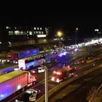 <p>A coach bus, far left, is stopped on I-95 north in Norwalk after a state trooper-involved shooting. </p>