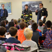<p>Firefighters of the Valhalla Fire Department talk to students about fire safety. </p>