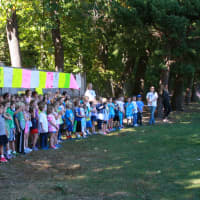 <p>Holmes School principal Paula Bleakley welcomes first-graders to the walk-a-thon.</p>