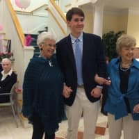 <p>A Darien High School student is flanked by two Atria Darien Assisted Living residents at the Oct. 14 Pretty in Pink fashion show.</p>