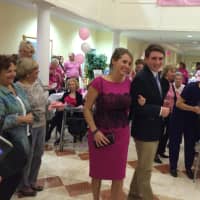 <p>A woman dressed in pink gets escorted by a Darien High student during the Pretty in Pink fashion show, a fundraiser for the Women&#x27;s Breast Center at Stamford Hospital.</p>