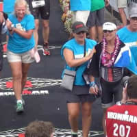 <p>Easton&#x27;s Chris Thomas receives assistance at the finish line after finishing the grueling 140.6 mile event in just over 9 hours.</p>