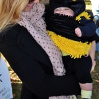 <p>A baby is dressed as bumblebee. </p>
