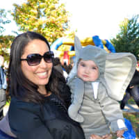 <p>A mother and baby dressed as an elephant take a photo at the parade. </p>