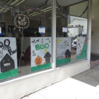 <p>Halloween images line the windows of Harrison Soap and Suds.</p>