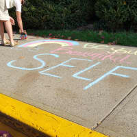 <p>Colorful messages adorn the sidewalk outside Kings Highway Elementary in Westport as part of the Kindness in Chalk movement.</p>