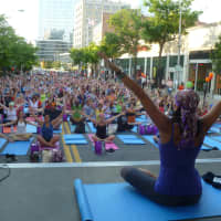 <p>Gwen Lawrence of White Plains leads more than 500 people in an outdoor mega yoga class Wednesday evening on Court Street in White Plains.</p>