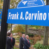 <p>Frank Corvino, Greenwich Hospital President and CEO, front right, standing underneath the street sign for a section of Perryridge Road named in his honor. He is retiring after 26 years with the hospital, the last 23 as its leader.</p>