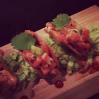 <p>The menu at NoMa social changes four times a year based on the seasons. Pictured here, arctic char tartare tacos.</p>
