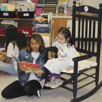 <p>A high school student reads to a future class of 2027 student.</p>
