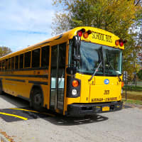 <p>A school bus goes over the John Jay High School campus. </p>
