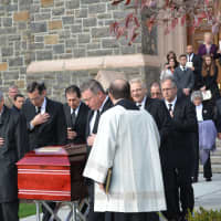 <p>The casket of Monsignor Daniel Flynn was brought outside moments before it is placed into a hearse.</p>