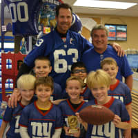 <p>Giants meet a Giant: Karl Nelson poses for photos with members of a Mahopac flag football team.</p>