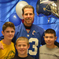 <p>Retired Giant Karl Nelson poses for a photo with Lucas Kowalski (left), Mason Nocito (center) and Nick Verrino (right). The three boys are 13 and live in Shrub Oak.</p>