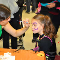 <p>Children get their faces painted at the parade. </p>