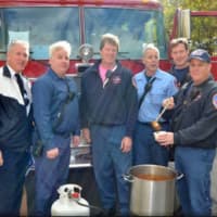 <p>Deputy Fire Chief Rich Houlihan (far left), along with members of the White Plains Fire Department, serving up bowls of their homemade chili to Fall Festival 
attendees.</p>