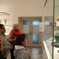 <p>Teens and staff look at an exhibit. </p>
