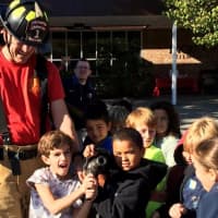 <p>Children get a chance to experience real hoses. </p>