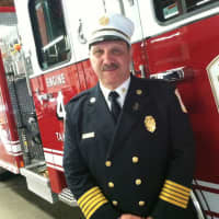 <p>Wilton Fire Chief Ronald Kanterman stands in front of the new fire engine that the Wilton Fire Department officially welcomed into its service Wednesday.</p>