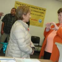 <p>Stamford resident Mirella Liotta, left speaks with Department of Motor Vehicles Commissioner Melody A. Currey at the opening of the new DMV office in Stamford. Liotta was one of the first customers to use it Thursday.</p>
