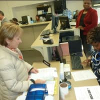 <p>Stamford resident Mirella Liotta, left, at the new Department of Motor Vehicles office in Stamford Thursday morning. Liotta was one of the first customers to use it on its first day of business.</p>