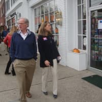 <p>Foley and Stevenson, followed by a crowd of supporters, take a stroll down Post Road in downtown Darien Friday.</p>