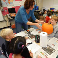 <p>Parent volunteers distributed pumpkins for the class. </p>