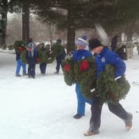 <p>Volunteers brave the snow to lay wreaths on veterans&#x27; graves at the Wreaths Across America ceremony in Darien.</p>