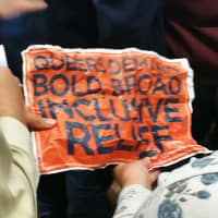 <p>His sign said, &quot;Queers demand bold broad inclusive relief.&quot;</p>