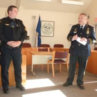<p>Wilton Police Chief Michael Lombardo, at right, speaks during the promotion ceremony for Sgt. David Hartman Monday at the Town Hall Annex.</p>