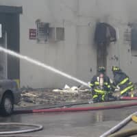 <p>Mount Vernon firefighters spraying the front of Artuso&#x27;s Pastry Shop in Mount Vernon.</p>