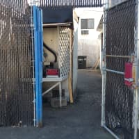 <p>A look from outside the entrance to the back alleyway of the Seagrape Cafe, located in the back left corner of its parking lot. A sign shown above marks it as &quot;private property.&quot;</p>