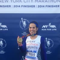 <p>Kristen Kirkland of Croton, who ran for the non-profit Every Mother Counts, shows off her medal. Kirkland finished her second marathon in three weeks. She also ran the Chicago Marathon in October.</p>